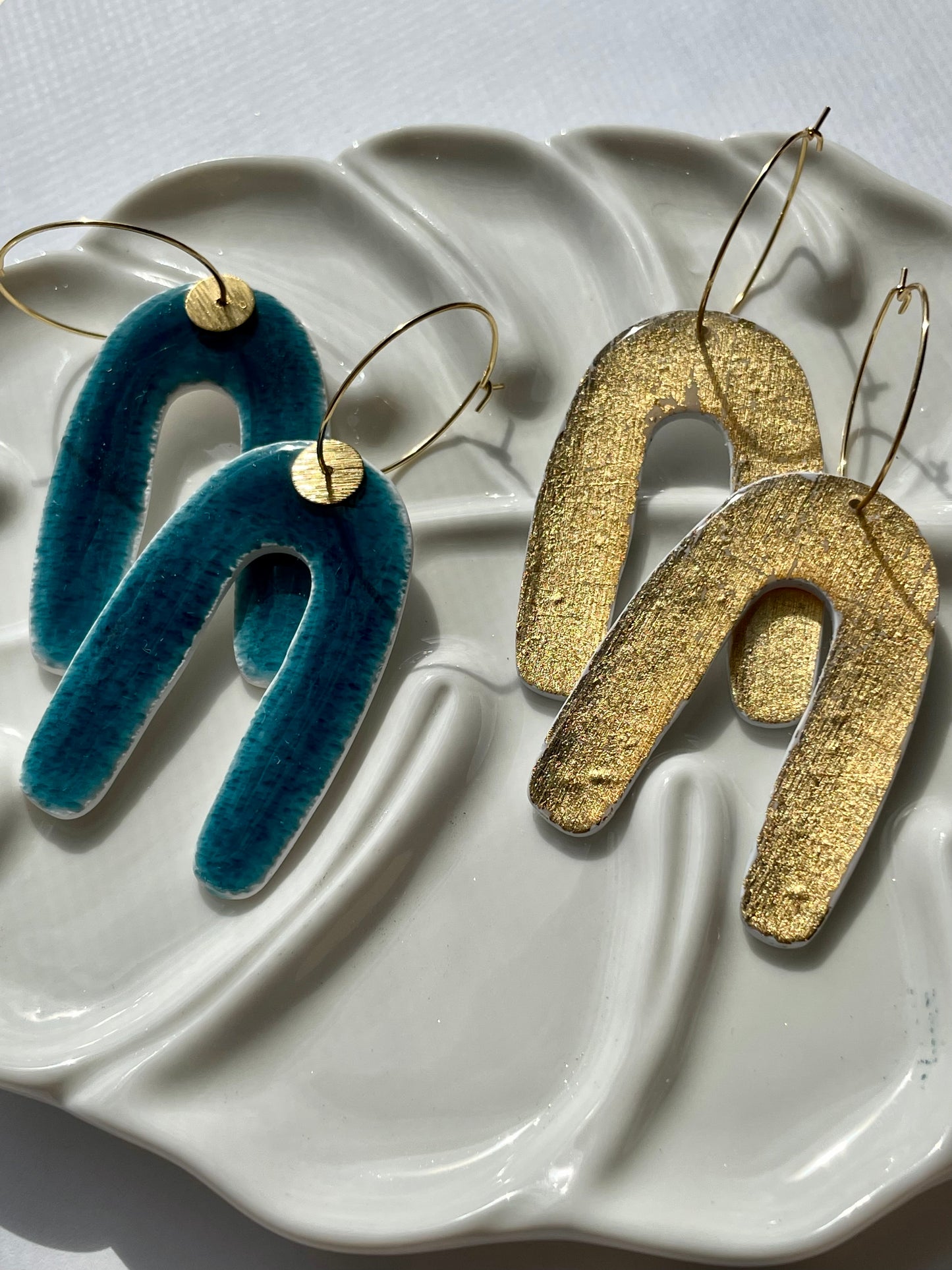 Colored coy arch dangles